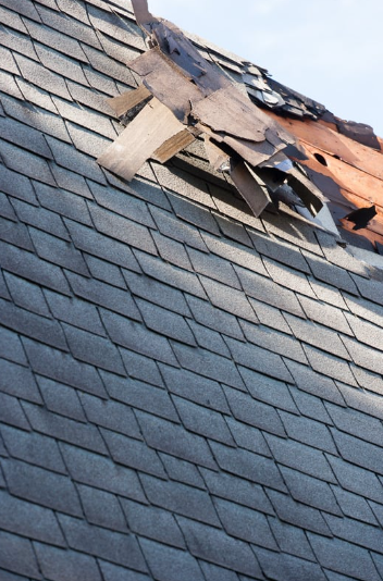 Severestorm damage to asphalt shingle roof needing urgent rep air